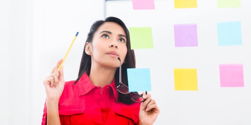 A woman managing too many project reports.